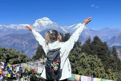 Trekker taking photo at Poon Hill with Dhaulagiri Mountain