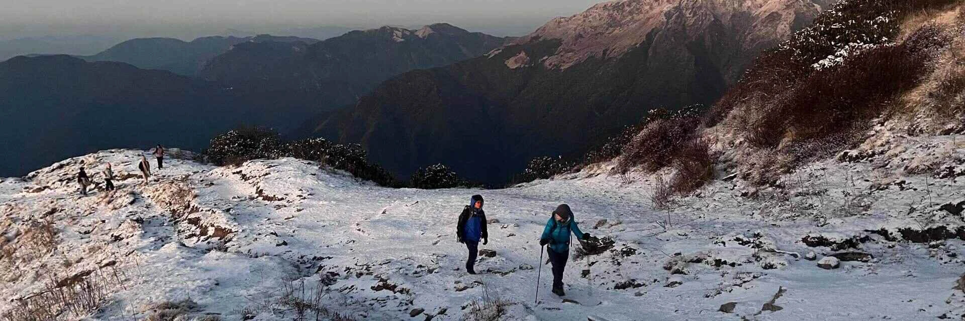 Trekker walking on a frost-covered Mardi Himal trail to Mardi Base Camp