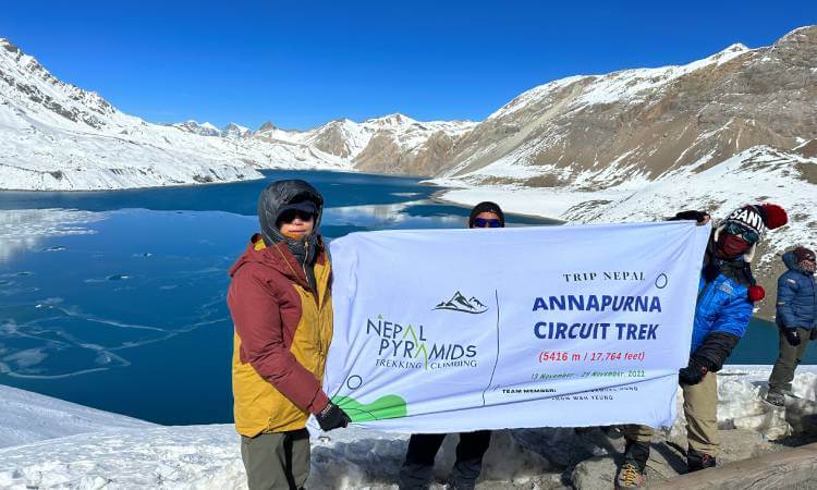 Trekking group on Annapurna Circuit approaching Tilicho Lake, the world's highest lake in Nepal