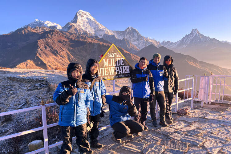 Trekkers at Muldai Viewpoint during a short trek in Nepal with mountain backdrop