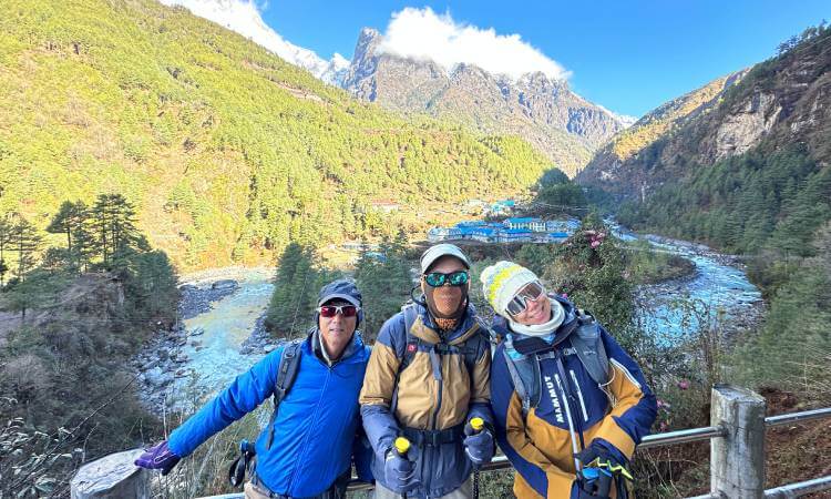 Trekkers resting on a hybrid trekking trail that connects remote valleys in Nepal Himalayas