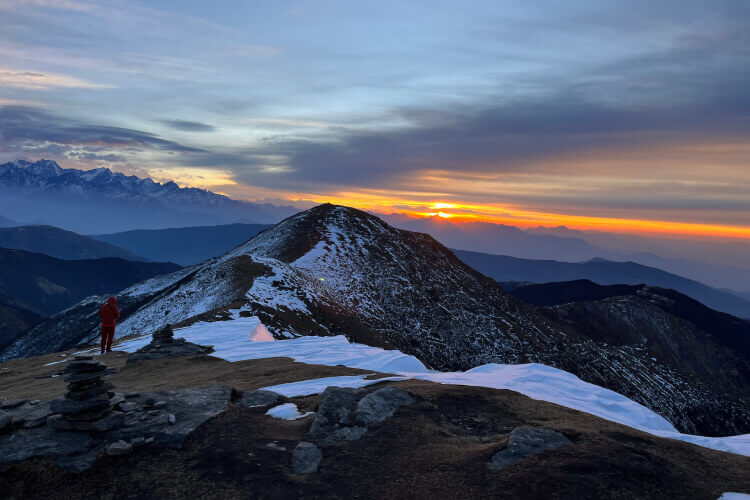Golden sunrise hitting snowy peaks range from Pikey Peak summit at 4,065 meters